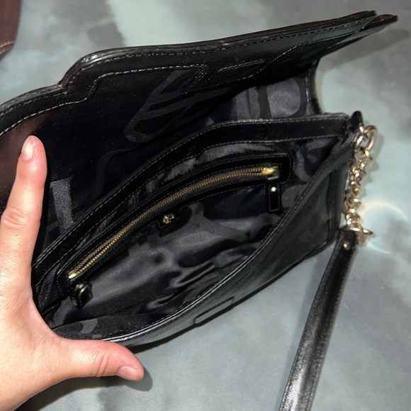 Sleek black faux leather Banana Republic purse with gold accents. - Picture 2 of 4